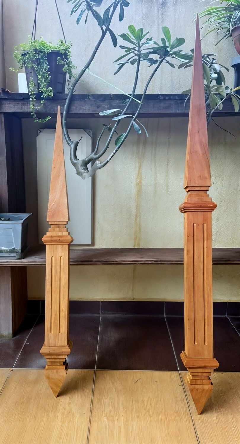 A pair of hand-carved Chengal roof finials — tunjuk langit